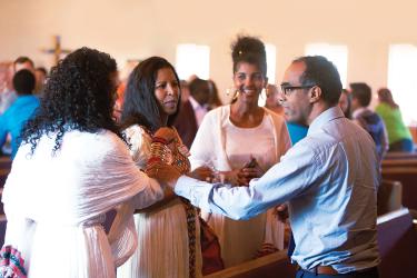 People standing in a circle and talking